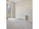 Bright living room with gray carpet, white walls, and large windows showcasing city views at 130 N Pearl St # 1103, Denver, CO 80203