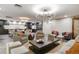 Open living space featuring modern chandelier, designer furniture, and dark hardwood floors leading to a kitchen area at 130 N Pearl St # 1103, Denver, CO 80203