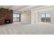 Bright living room with fireplace, carpet and sliding glass doors that open to a private balcony at 130 N Pearl St # 1103, Denver, CO 80203