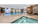 Indoor pool and spa with brick walls, tile floors, and ample seating for relaxation at 130 N Pearl St # 1103, Denver, CO 80203