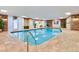 Indoor pool area featuring brick accent walls, tile flooring, and ample natural light from glass block windows at 130 N Pearl St # 1103, Denver, CO 80203