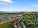 Scenic aerial view of the neighborhood showcasing the property's location near a lake and green spaces at 2089 Meadow Sweet Ln, Erie, CO 80516