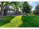 Beautiful backyard with lush green lawn, patio, and mature trees offering shade and privacy at 2089 Meadow Sweet Ln, Erie, CO 80516