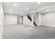 Expansive finished basement with neutral carpeting, recessed lighting, and staircase access to upper level at 2089 Meadow Sweet Ln, Erie, CO 80516