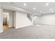 Large finished basement features neutral carpeting, recessed lighting, and stairs to the main floor at 2089 Meadow Sweet Ln, Erie, CO 80516