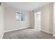 Bedroom featuring an egress window and neutral carpeting and paint and white trim at 2089 Meadow Sweet Ln, Erie, CO 80516