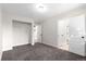 Bright bedroom featuring plush carpeting, an open closet and a pristine white trim and doors at 2089 Meadow Sweet Ln, Erie, CO 80516