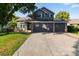 Charming two-story home with a three-car garage, well-manicured lawn, and solar panels at 2089 Meadow Sweet Ln, Erie, CO 80516