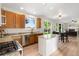 Bright kitchen boasts stainless appliances, granite counters and a large center island with backyard views at 2089 Meadow Sweet Ln, Erie, CO 80516