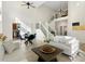 Bright, open living room with soaring ceilings, dining area, and modern staircase at 2089 Meadow Sweet Ln, Erie, CO 80516