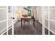 Cozy office with neutral carpeting, bright natural light, and French doors at 2089 Meadow Sweet Ln, Erie, CO 80516