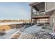 Backyard featuring a stone patio, an upper-level deck and stairs that connects both outdoor spaces at 15842 Willow St, Brighton, CO 80602