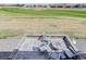 Back patio featuring a fire pit and golf course views, ideal for outdoor enjoyment at 15842 Willow St, Thornton, CO 80602