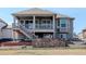 Exterior showcasing a large balcony, a stone patio, and a well-maintained backyard, perfect for outdoor living at 15842 Willow St, Thornton, CO 80602