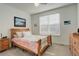 Cozy bedroom featuring a comfortable bed with colorful bedding, soft carpet, and a bright window at 15842 Willow St, Thornton, CO 80602