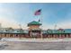 An American flag flies proudly over the Heritage Todd Creek clubhouse. Beautiful architecture and well-maintained landscaping at 15842 Willow St, Thornton, CO 80602