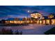 Evening view of the well-lit clubhouse entrance. Paver driveway leads to the main entrance at 15842 Willow St, Thornton, CO 80602