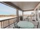 Covered deck with outdoor seating overlooking a winter landscape at 15842 Willow St, Thornton, CO 80602