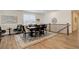 Bright dining room features a dark wood table, six chairs, and decorative rug on hardwood floors at 15842 Willow St, Thornton, CO 80602