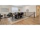 Traditional dining room with wood table, neutral upholstered chairs, and a blue patterned rug on wood floors at 15842 Willow St, Thornton, CO 80602