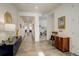 Bright entryway with white walls, wood floors, a hallway, and stylish furniture pieces at 15842 Willow St, Thornton, CO 80602