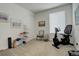 Bright exercise room featuring workout equipment, neutral carpet, and a well-lit window at 15842 Willow St, Thornton, CO 80602