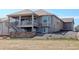 Exterior showcases a spacious balcony, a stone patio, and a well-maintained backyard, perfect for outdoor enjoyment at 15842 Willow St, Thornton, CO 80602