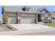 Charming home showcasing a three-car garage, brick accents, and well-manicured landscaping, creating a welcoming curb appeal at 15842 Willow St, Thornton, CO 80602