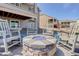 Inviting outdoor fire pit area with rocking chairs, perfect for entertaining and relaxation at 15842 Willow St, Thornton, CO 80602