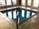 Indoor hot tub with tile surround and nearby windows to let in natural light at 15842 Willow St, Thornton, CO 80602