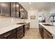 Modern kitchen featuring stainless steel appliances, light countertops, and dark wood cabinets at 15842 Willow St, Thornton, CO 80602