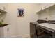 Practical laundry room featuring modern appliances, shelving, sink and ample counter space at 15842 Willow St, Thornton, CO 80602