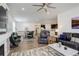 Spacious living area featuring a fireplace, open floorplan, dining space, kitchen, and comfortable leather seating at 15842 Willow St, Thornton, CO 80602