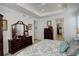 Spacious main bedroom with a tray ceiling, large dresser with mirror, and a walk-in closet at 15842 Willow St, Thornton, CO 80602
