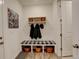 Well-organized mud room with bench seating, storage baskets, and convenient coat hooks at 15842 Willow St, Thornton, CO 80602