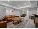 Spacious finished basement with a large leather couch and colorful area rug at 8354 Big Thompson St, Littleton, CO 80125