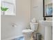 Charming powder room featuring patterned tile floors and modern fixtures at 8354 Big Thompson St, Littleton, CO 80125