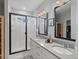 Bright bathroom with double sinks, modern fixtures, and a glass-enclosed shower for a spa-like experience at 8354 Big Thompson St, Littleton, CO 80125