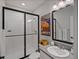 Modern bathroom featuring a glass-enclosed shower and sleek vanity at 8354 Big Thompson St, Littleton, CO 80125