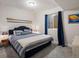 Comfortable bedroom with blue bedding, oars as decor, and natural light at 8354 Big Thompson St, Littleton, CO 80125