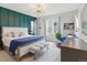Beautiful bedroom with designer lighting, accent wall, and patterned area rug at 8354 Big Thompson St, Littleton, CO 80125