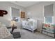 Bright Bedroom with crib, chair, and decor creating a warm and inviting space for baby at 8354 Big Thompson St, Littleton, CO 80125
