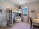Cozy bedroom featuring a unique bunk bed, playful wallpaper, and soft, inviting textures at 8354 Big Thompson St, Littleton, CO 80125