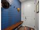 Modern entryway with custom blue shiplap accent wall and coat hooks at 8354 Big Thompson St, Littleton, CO 80125