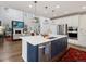 Bright kitchen features a large island, stainless steel appliances and modern pendant lighting at 8354 Big Thompson St, Littleton, CO 80125
