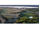 Scenic landscape with lush greenery, winding trails, and a tranquil lake in the distance at 8354 Big Thompson St, Littleton, CO 80125