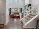 Bright entryway with hardwood floors leading into a living room with soaring ceilings and plentiful windows at 8354 Big Thompson St, Littleton, CO 80125