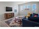 Relaxing living room offers lots of natural light and a variety of seating options at 8354 Big Thompson St, Littleton, CO 80125