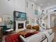 Open living room with high ceilings, a fireplace, hardwood floors, modern furnishings, and cable railing system at 8354 Big Thompson St, Littleton, CO 80125