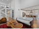 Open-concept living room boasts hardwood floors, tall ceilings, and seamless kitchen access at 8354 Big Thompson St, Littleton, CO 80125